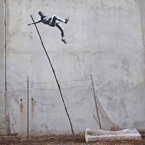 London 2012 street art by Banksy - pole vault with barbed wire and mattress