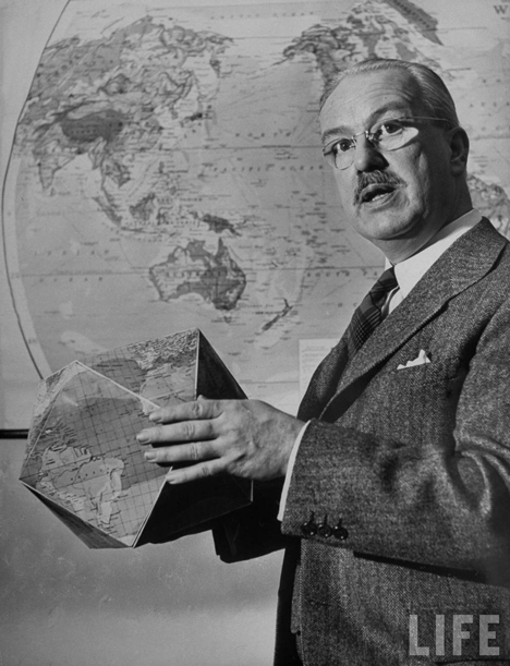 R. Buckminster Fuller with Dymaxion Map as a globe