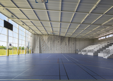 Sports centre clad with sun-bleached wooden slats by Explorations Architecture