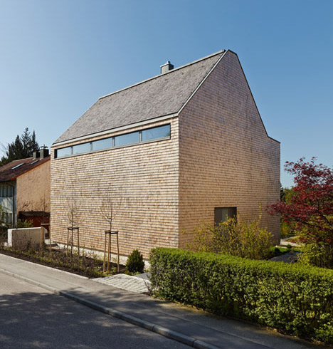 Stuttgart house by (se)arch with shingle-clad walls and a triple-height art gallery