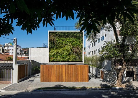 Wall of bushy plants fronts Sao Paulo housing block by TACOA