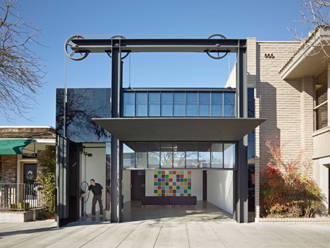 Gears and pulleys are used to lift up the facade of this California gallery