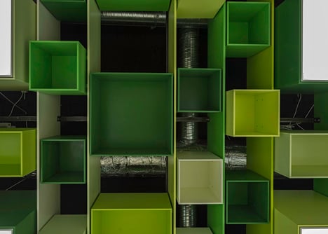Green boxes cover the ceiling of Clip Drop In hair salon by Sweco Architects