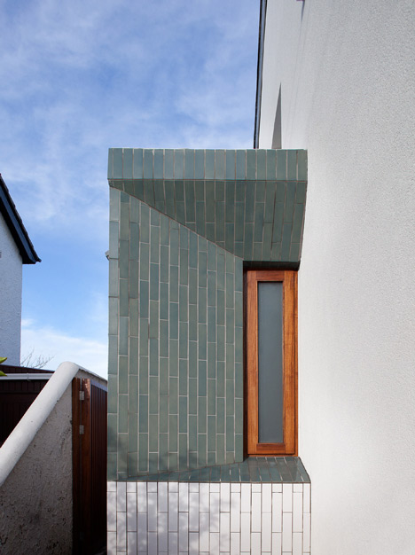 Tile-covered walls reflect light into Greenlea Road extension by GKMP Architects