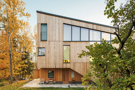 Timber-clad House M-M by Tuomas Siitonen wraps around a sheltered garden