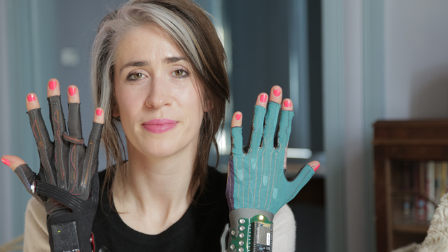 Imogen Heap with two versions of her gestural gloves