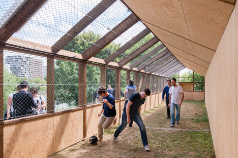 Guinée*Potin Architectes creates "footcheball" playground inside a thatched shed