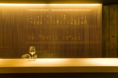 The Coure restaurant in Barcelona displays copper-coloured curtains. LED lighting plays with transparencies