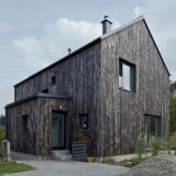 Mjölk Architekti's Carbon house features a burnt wood exterior