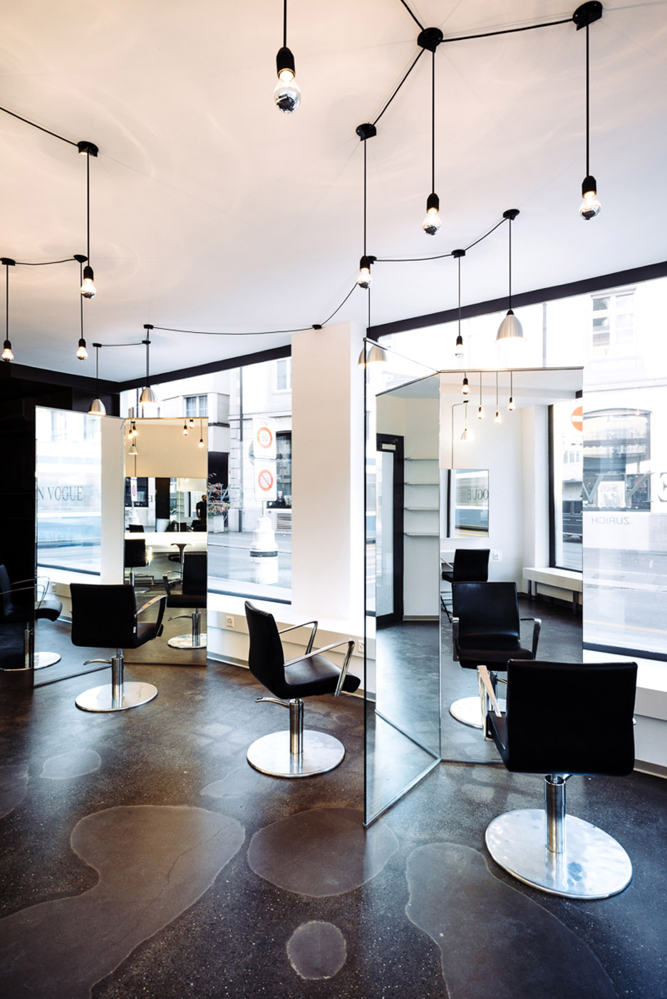 Sculptural mirrors frame spaces in Zurich barbershop by Wülser Bechtel Architekten