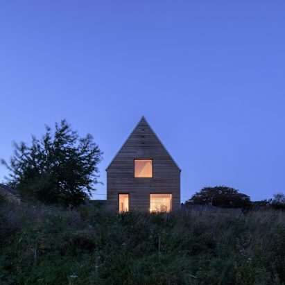 Steep gable defines barn-style house in rural England by Elliott Architects