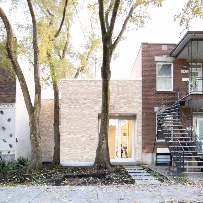 TBA adds pale brick volume to traditional Montreal "shoebox" home