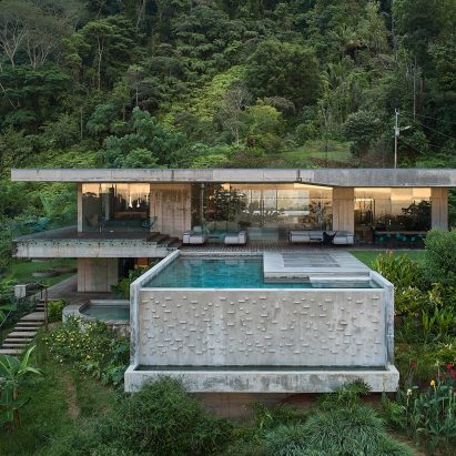 Concrete swimming pool protrudes from Art Villa holiday home in Costa Rican jungle