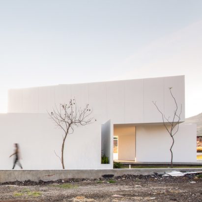 Splayed and stacked white volumes form San Antonio House in Mexico