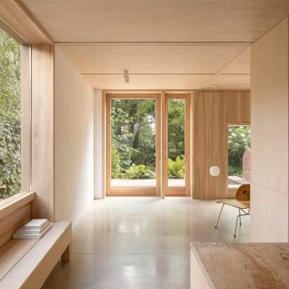 Grove Park house by O'Sullivan Skoufoglou Architects has wooden lining and verdant views
