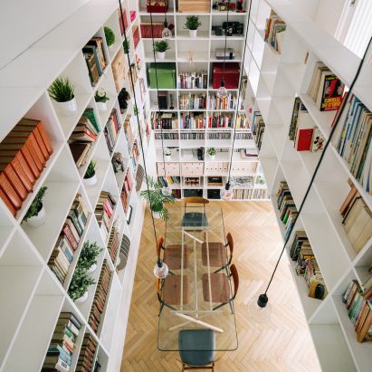 Two-storey bookshelf rises inside renovated Madrid house
