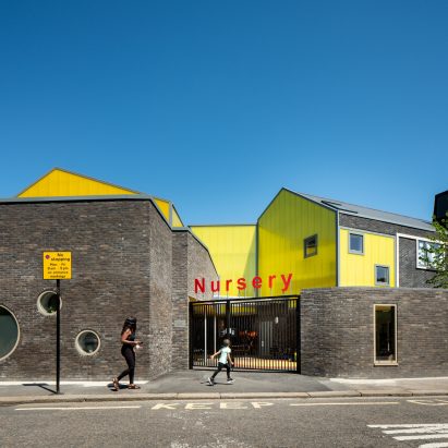 Grey brick and yellow polycarbonate contrast to create striking Peckham primary school