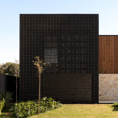 Perforated black blocks screen Cobogós House in Brazil by MF+ Arquitetos