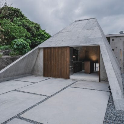 IGArchitects adds pyramidal concrete home to sloping site in Okinawa