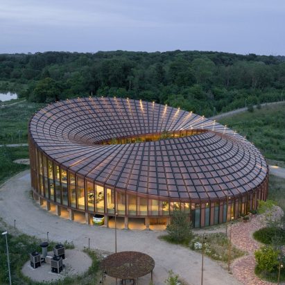 BIG arranges circular Dymak HQ around stepped courtyard