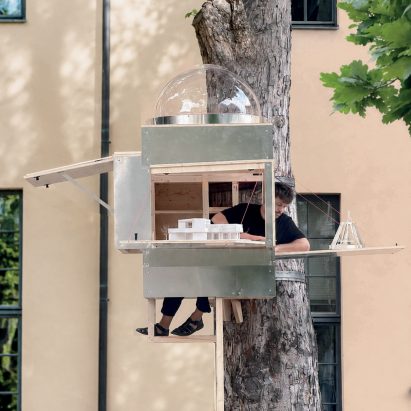 Square-metre studio strapped to tree in "exaggerated response" to office rental prices