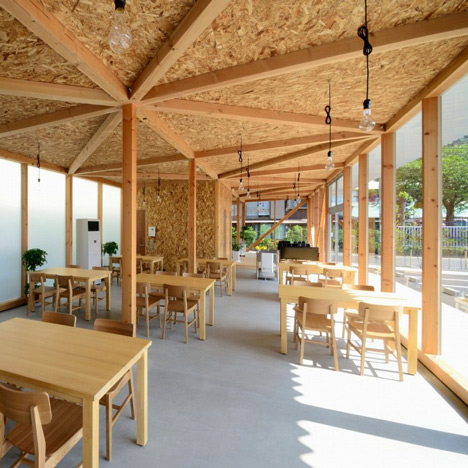 Cafeteria with exposed timber framework by Niji Architects