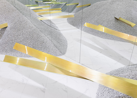Golden girders protrude from piles of gravel to display sunglasses