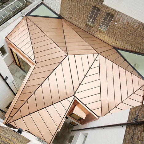 Office extension with a faceted copper roof by Emrys Architects