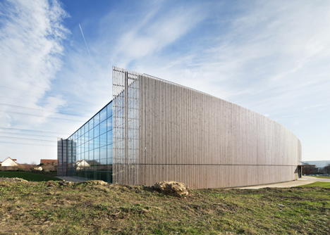 Sports centre clad with sun-bleached wooden slats by Explorations Architecture