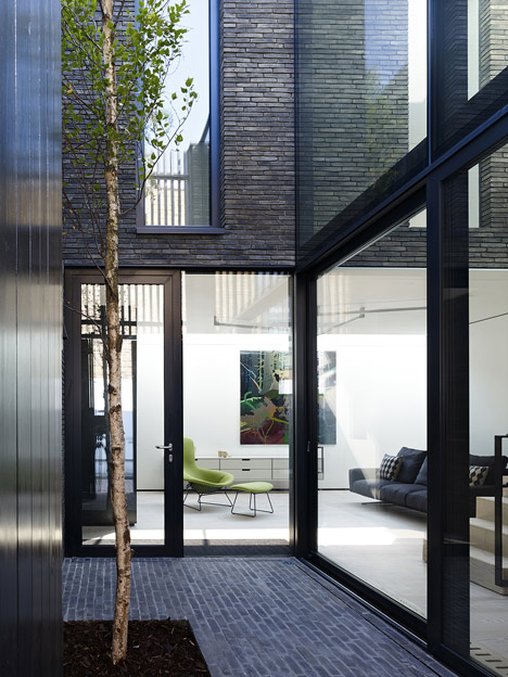 Blackbox mews house by Form_art Architects has brick walls that continue inside
