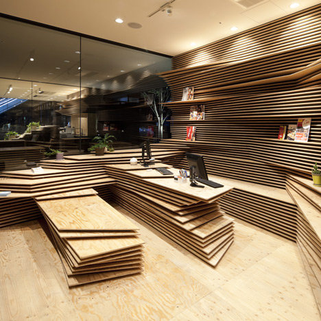 Kengo Kuma stacks wooden layers inside office and cafe