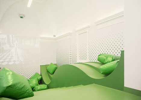 Wavy green lounge in a Solvenian school by Svet Vmes Architects