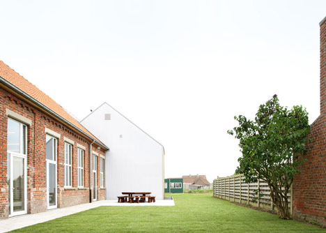 Community Centre Woesten by Atelier Tom Vanhee has a contrasting gabled extension