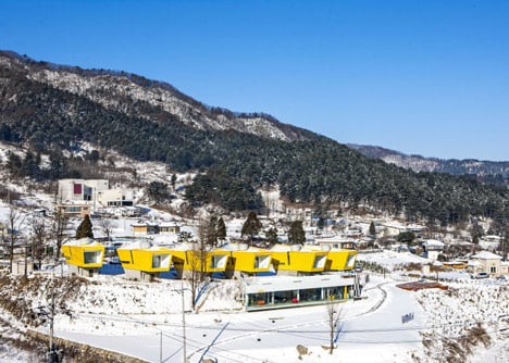 Asymmetric holiday homes by Studio Koossino feature bright yellow walls