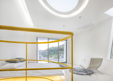 Asymmetric holiday homes by Studio Koossino feature bright yellow walls