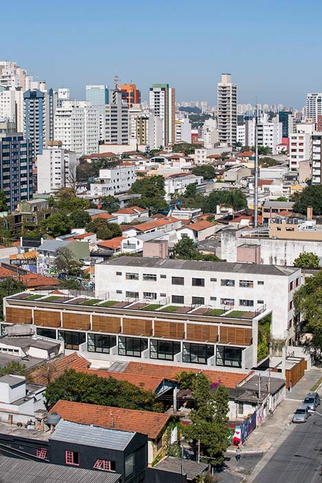 Wall of bushy plants fronts Sao Paulo housing block by TACOA