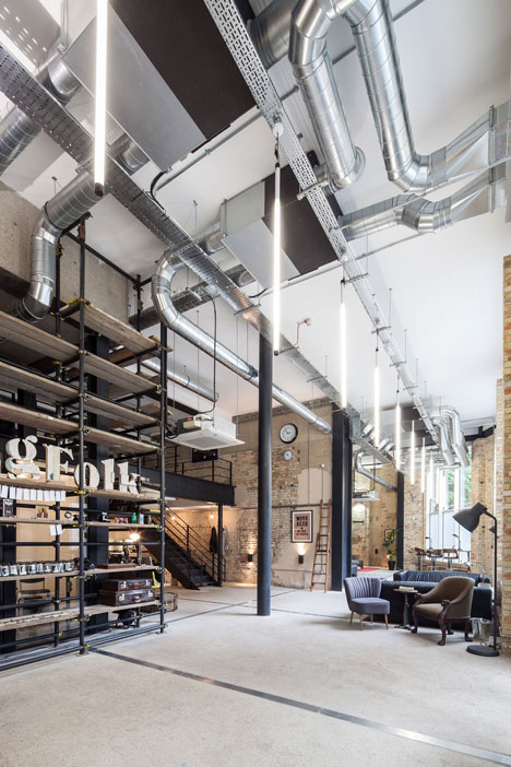 Industrial-style offices by DH Liberty mix reclaimed objects with minimal aesthetic 