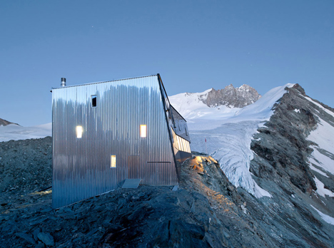 Steel-clad mountain hut by Savioz Fabrizzi Architectes wraps over an Alpine ridge