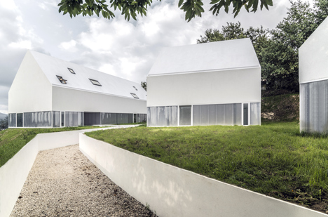 White buildings sink into the landscape at the White Wolf Hotel by AND-RÉ