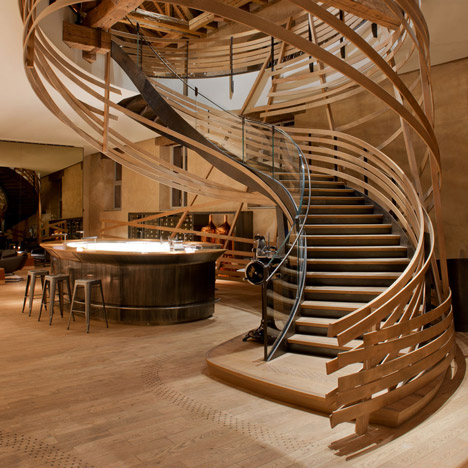 Wooden strips coil around staircase at Strasbourg hotel by Jouin Manku