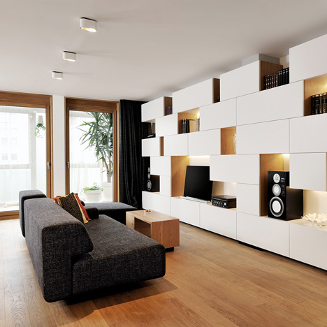 Studio 360 adds walls of modular shelving and storage to Slovenian apartment