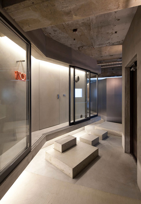 Bare concrete apartment by Airhouse Design Office presents its own fashion exhibitions