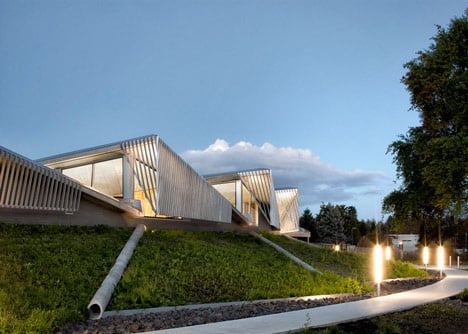 Water treatment facility by Skylab Architecture features a roof of grass-covered fins