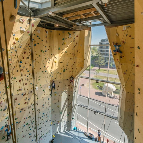 Cave-like apertures frame climbing walls at NL Architects' Spordtgebouw sports centre