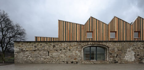 3+1 Architekti converts a stone barn into a woodwork facility with a serrated timber extension