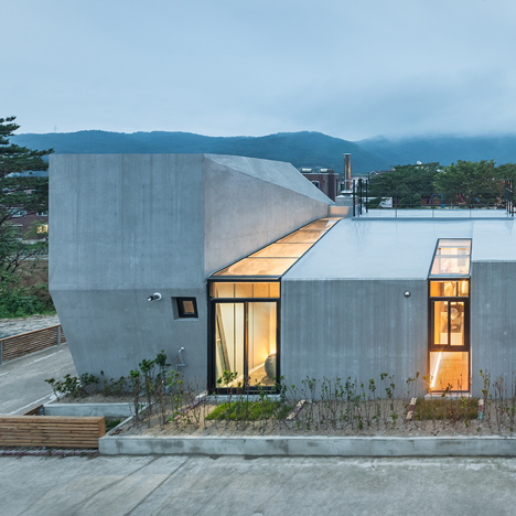 Concrete Voidwall house by AND is punctured by glazed incisions