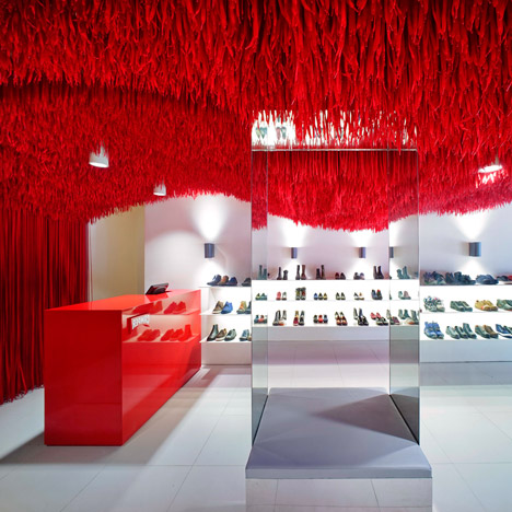 30,000 red shoelaces hang from the ceiling of Melbourne's Camper store