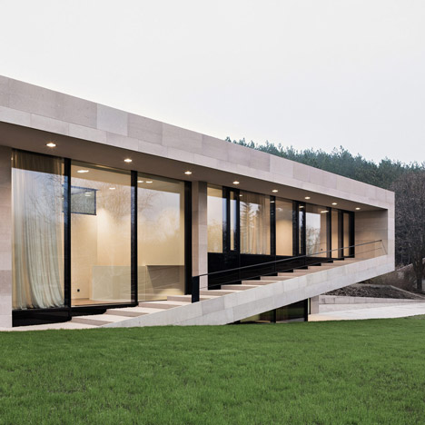 Stone house in Bulgaria by I/O Architects features a veranda that steps up and down