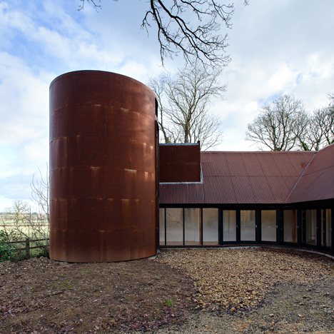 Chris Dyson Architects adds a rusty steel tower to a rural stone cottage