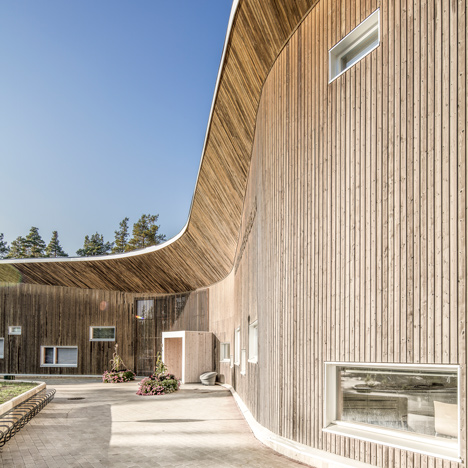 Curving wooden wall fronts Ruukki Health Clinic in Finland by Alt Arkkitehdit